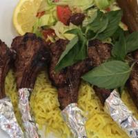 Grilled Lamb Chops · five lamb chops served with rice.