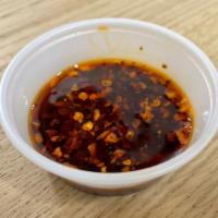 Chili Oil · Soybean oil infused with herbs then mixed with spices and chili. Very Spicy!!!