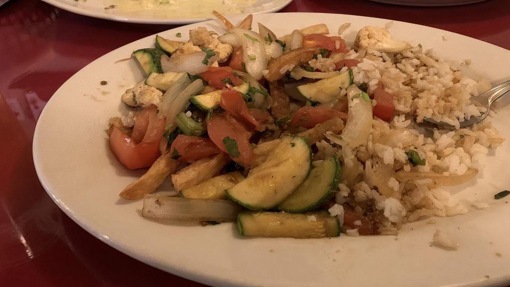 Saltado Mixto · Lean beef, chicken and shrimp, sautéed with onions, tomatoes. Served on top of fries and rice.