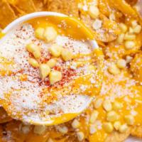 Volcano De Elote · Your choice of chips (Tostitos, Hot Cheetos, Cheeto Puffs, Doritos, Takis) with a Cup of Esq...