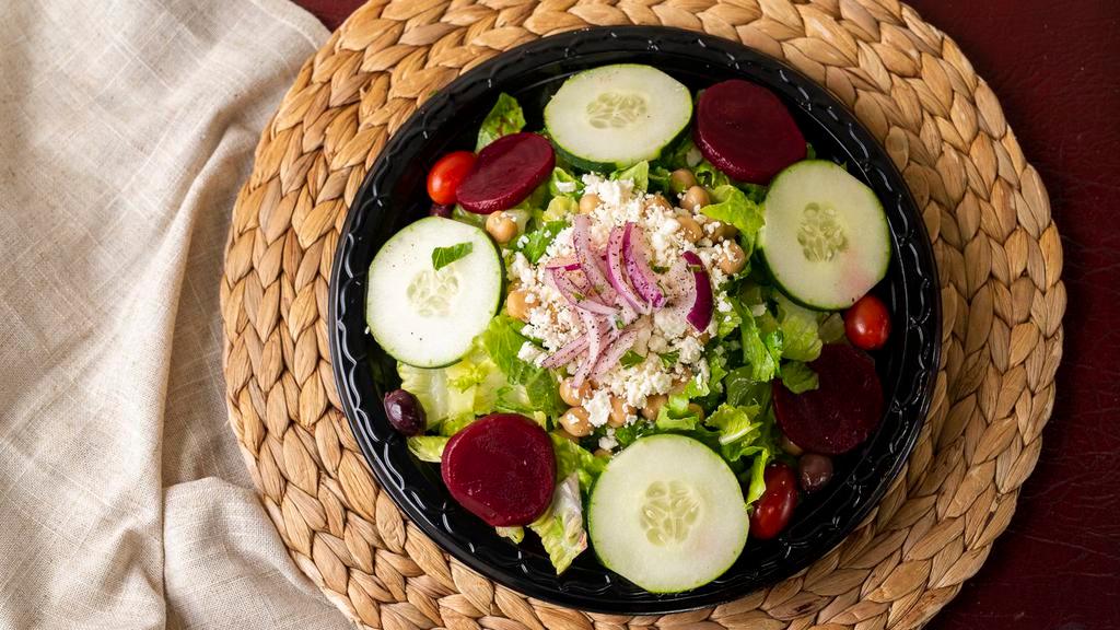 Greek Salad · Romaine lettuce, tomatoes, cucumbers, onions, kalamata olives, chickpeas, beets, and feta cheese.