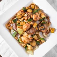 Kung Pao King · Chicken, beef, shrimp and roasted peanuts with diced vegetables. Cooked in special spicy sau...