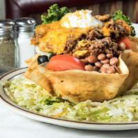 Taco Salad · Beef or chicken and whole beans on salad greens, served in a crisp tortilla shell, and garni...