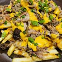 Pulled Pork Fries · Crispy fries topped with hickory smoke pork and drizzled with our famous BBQ sauce and cheese.