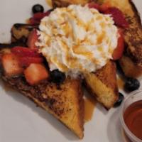 French Toast · Three half slices of thick Texas brioche toast dipped into a rich creamy batter with hazelnu...