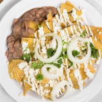 Chilaquiles · Fried corn tortillas, green salsa, sour cream, cheese, onion, cilantro.