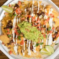 Nachos · Corn chips topped with all choices of meat, shredded cheese, pinto beans, pico de gallo, gua...