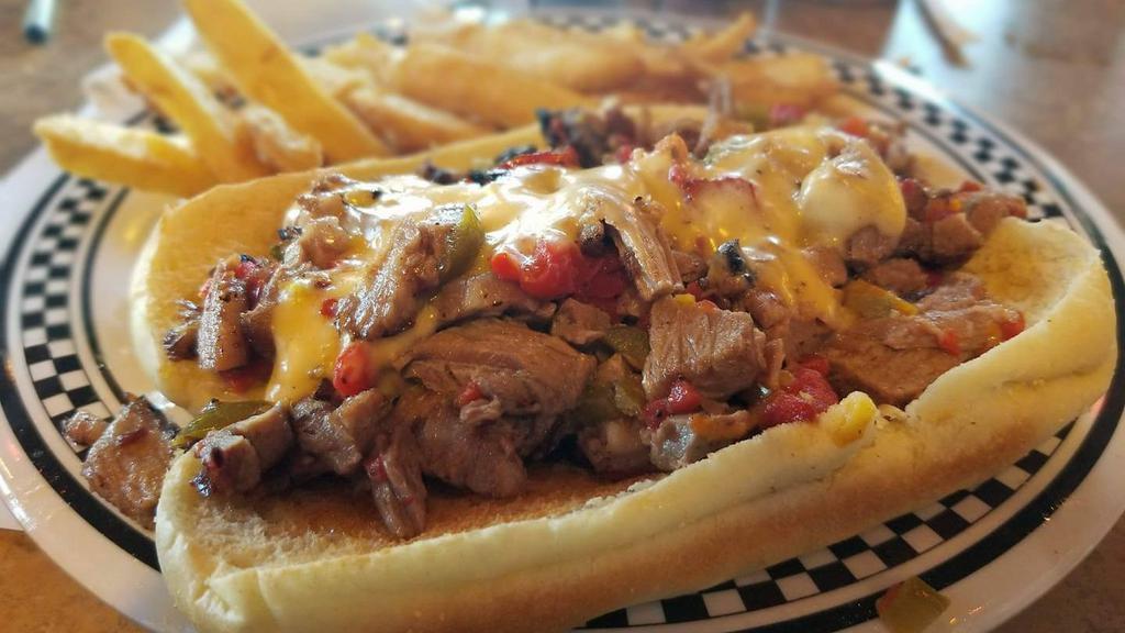 Beef Brisket Philly · Toasted hoagie with beef brisket, sauteed onion, jalapenos and red peppers topped with our homemade mac sauce. Served with beer battered fries.