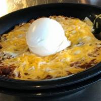 Bowl Of Brisket Chili · Homemade brisket chili with cheese, sour cream and onion on top.