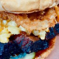 Brisket Sandwich · Tender slow smoked Prime Angus beef brisket on a toasted brioche
bun with crispy fried onion...