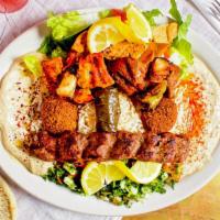 King Combo · A Mediterranean combination of hummus, baba ghanouj, tabbouleh, fattoush salad, rice, falafe...