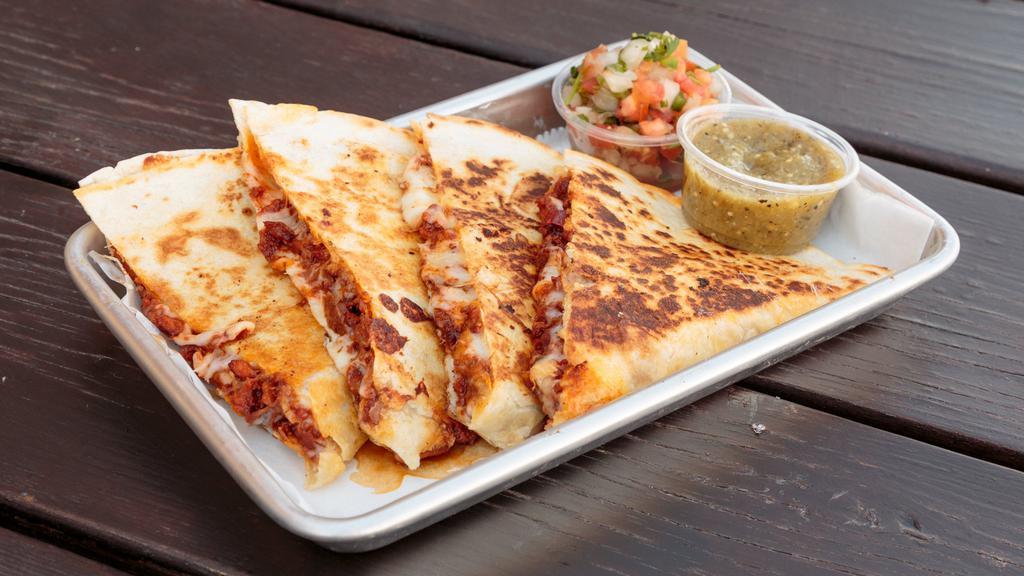 Quesadillas With Meat · Flour tortilla filled with melted cheese, choice of protein, pico de gallo, served with salsa and guacamole.