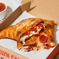 The Barclays · Calzone with sausage, pepperoni, bacon, ham, melted mozzarella, and a side of marinara.