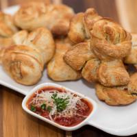 Garlic Knots · Strips of our famous pizza dough tied up in little knots, stuffed with fresh garlic, olive o...