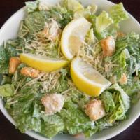 Caesar Salad · Romaine lettuce tossed with caesar dressing, croutons, lemon, and parmesan cheese.