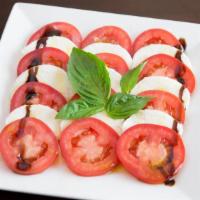 Caprese Salad · Made with fresh mozzarella, fresh basil, tomatoes, and extra virgin olive oil.