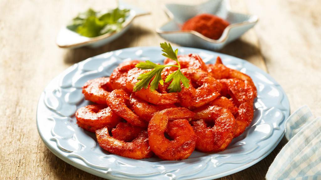 Tandoori Prawns · Delicious jumbo prawns marinated in a special combination of herbs and spices. Served with sliced onions and lemon.