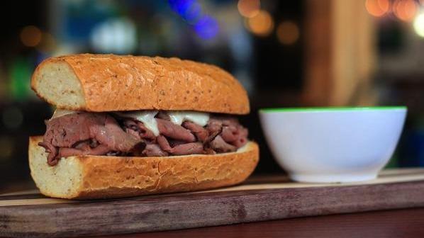 French Dip Sandwich · Boars Head Brand Roast beef with Swiss cheese and horseradish sauce, toasted on a sub roll served with a side of hot au jus.