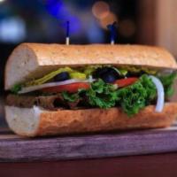 Veg-Italian Sandwich · Tofurky Deli Slices with provolone, topped with lettuce, tomato, onion, pickles, pepperoncin...