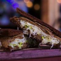 Veggie Reuben On Dark Rye Sandwich · Vegetarian. Double toasted with Tofurky Deli Slices and Swiss cheese, thousand island, light...