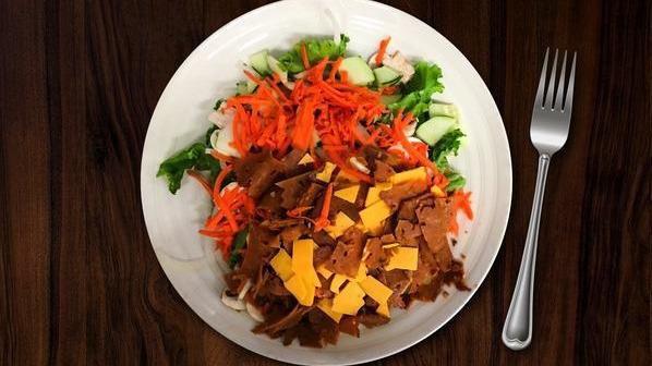 Tofurky & Cheddar Salad · Tofurky Deli Slices and Tillamook Cheddar cheese atop fresh green leaf lettuce piled high with tomato, onion, cucumbers, bell peppers, mushrooms, and carrots served with a dressing of your choice.