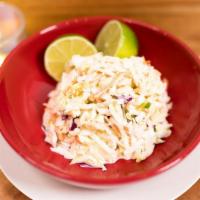 Coleslaw · Traditional Creamy Coleslaw Served w/ Raw Cabbage, Onions, & Carrots.