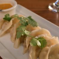 Momo · Dumplings of Himalayan origin (veggie or chicken), served with sesame-tomato sauce.