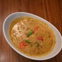 Dal Tarka-D · Gluten free. Slow simmered yellow lentils with an exotic house glaze.