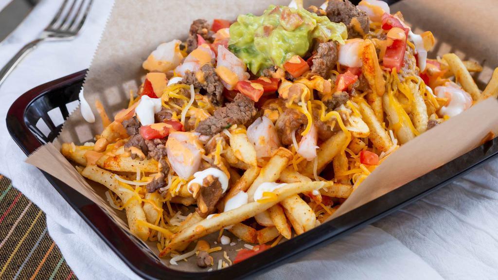 Spicy Carne Asada Fries · Fries topped with cheese, jalapeños, carne asada, red sauce and sour cream.