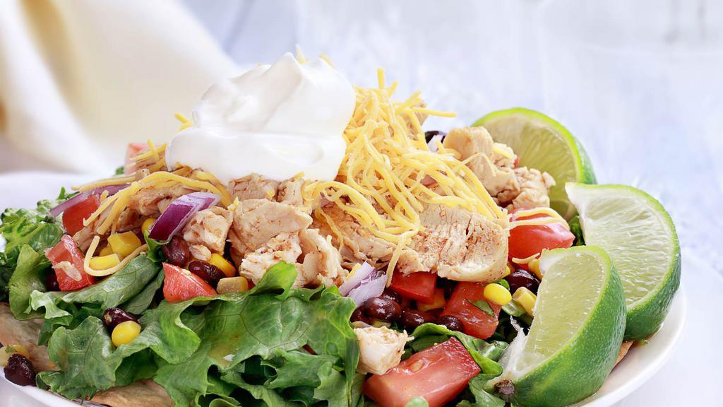 Chicken Tostada · Fresh chicken tostada with beans, lettuce and cheese.