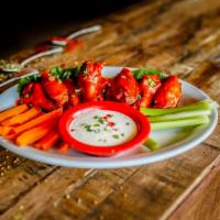 Chicken Wings · Spicy. Chicken wings tossed in buffalo wing hot sauce and garlic butter. Served with celery,...