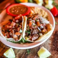 Tacos De Carnitas · Gluten-free. Two corn tortillas filled with tender flavorful slow-cooked pork, topped with p...
