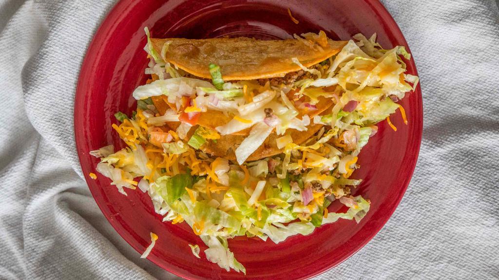 Taco · Choice of mixed cheese, shredded chicken, ground beef or shredded beef.