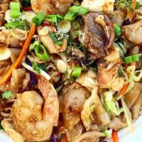 Drunken Noodles With Shrimp · Wide rice noodles stir fried with shrimp, topped with our cabbage medley, green onions, cila...