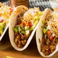 Taco Style · Ground beef, shredded cheese, tortilla chips with our house special blend dressings!