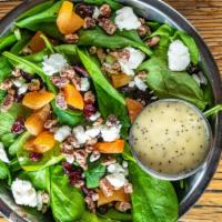 Spinach Salad · Dried cranberries and apricots, candied pecans, and goat cheese, tossed with spinach and pop...