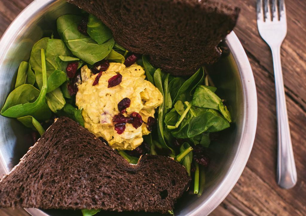 Curry Salad · Served open faced on spinach with a pumpernickel bread. Mixture of smoked chicken, celery, onion, apple, and curry.