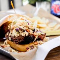 Brisket Sandwich · Smoked brisket topped with slaw and BBQ sauce and served on a brioche bun.