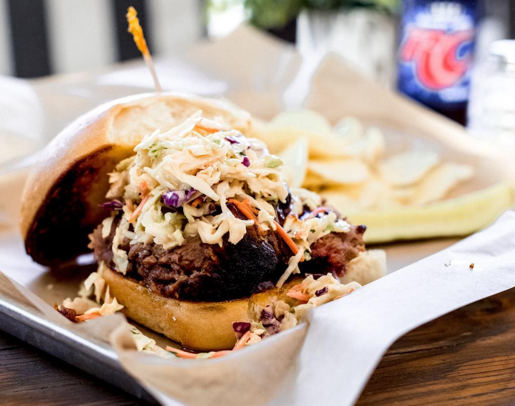 Brisket Sandwich · Smoked brisket topped with slaw and BBQ sauce and served on a brioche bun.