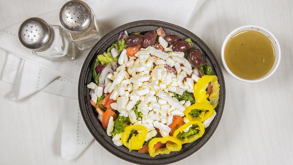 Greek Salad · Romaine lettuce, diced onions, diced tomatoes, feta cheese, Greek olives and banana peppers tossed in our homemade house dressing. Choice of small, large, or family.