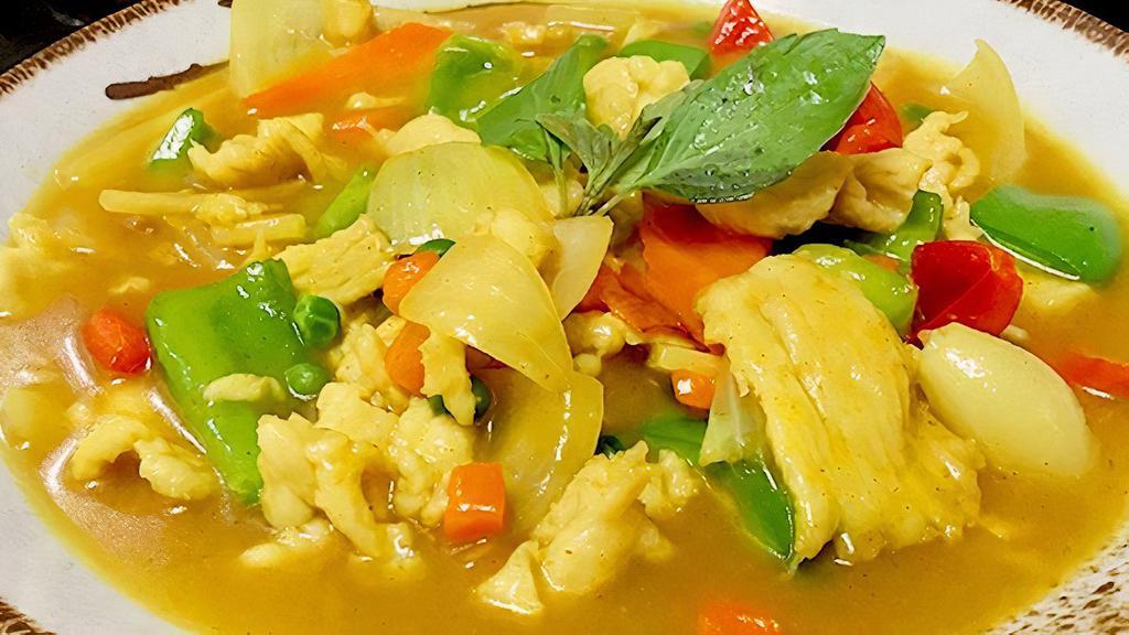 Yellow Curry With Chicken · Spicy.Green & red bell pepper, peas and carrots, bamboo and basil in yellow curry sauce with Chicken