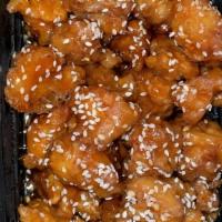 Sesame Chicken · Battered leg meat cooked with a sweet tangy sauce.