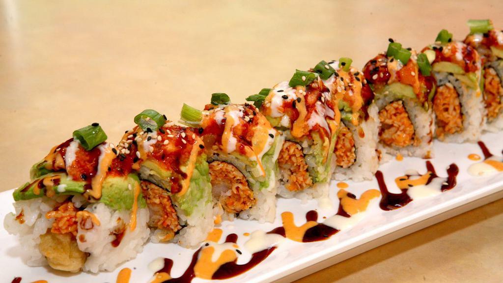 Sumo Roll · Shrimp tempura, spicy crab, cucumber topped with a layer of avocado, spicy salmon and scallions.