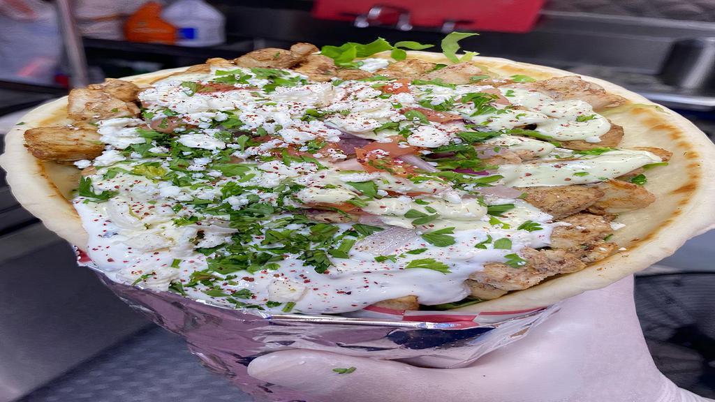 Double Chicken Shawarma Gyro · Shredded chicken with pita bread, garlic sauce, tomato, onion, lettuce, hummus and pickles.