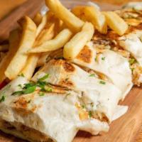 Chicken Arabi With Fries · Chicken shawarma Arabi warped in saj bread. Cut to small bite size pieces and served on a be...