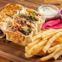 Beef Arabi With Fries · Beef shawarma Arabi warped in saj bread. Cut to small bite size pieces and served on a bed o...