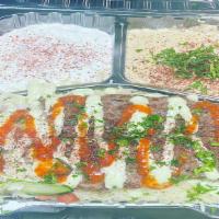 Beef Kabab Over Rice Plate · Beef, rice, mix salad, tzatziki, hummus mix spicy garlic sauce.