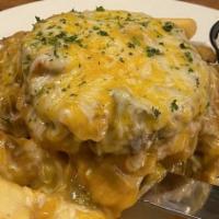 The Copper Slopper Burger · Served open faced over steak fries smothered in green chili and cheese and baked. Includes a...