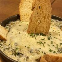 Spinach & Artichoke Dip · Baked spinach and artichokes in a creamy cheese sauce. Served with baked crostini.