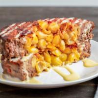 Mac And Cheese Meatloaf Madness · House-made meatloaf, stuffed with mac and cheese. Sliced thick and pan-seared. Topped with h...